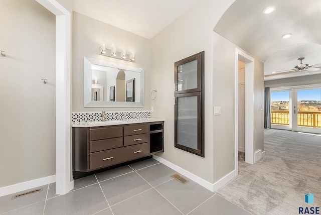 bathroom with vanity, decorative backsplash, tile patterned floors, and ceiling fan