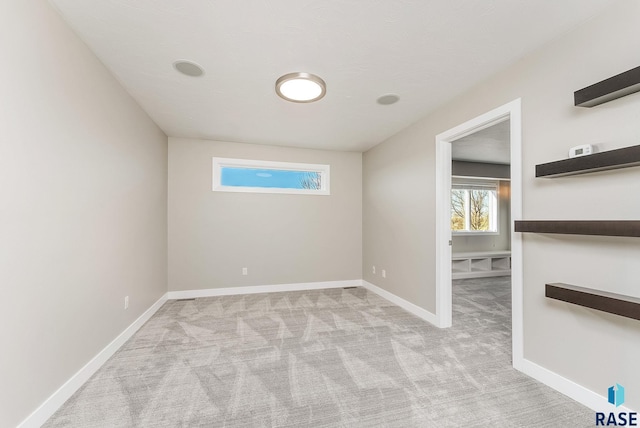 unfurnished room with light colored carpet