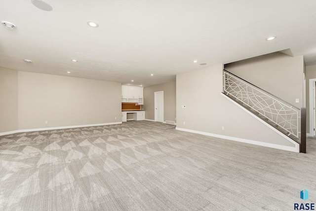 unfurnished living room with light carpet