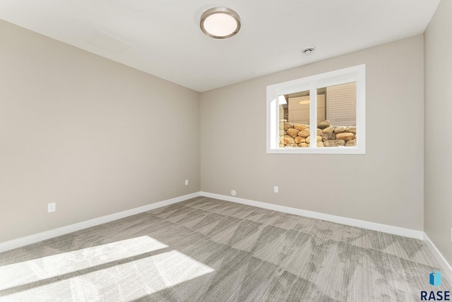 unfurnished room with light colored carpet