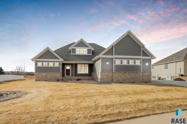 craftsman-style home with a yard