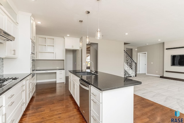 kitchen featuring sink, stainless steel appliances, dark hardwood / wood-style floors, white cabinets, and a center island with sink