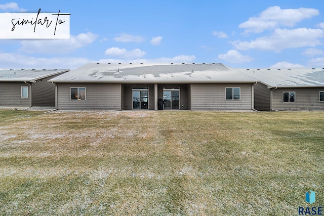 rear view of property with a lawn