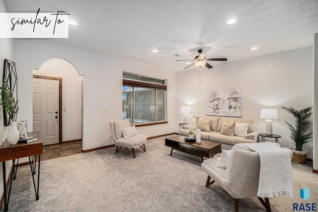 carpeted living room with ceiling fan and a textured ceiling