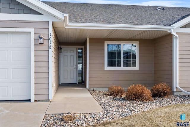 doorway to property with a garage