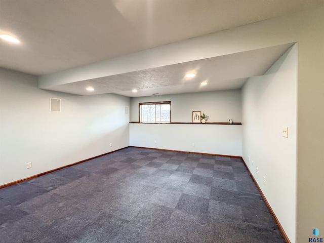 basement featuring dark carpet