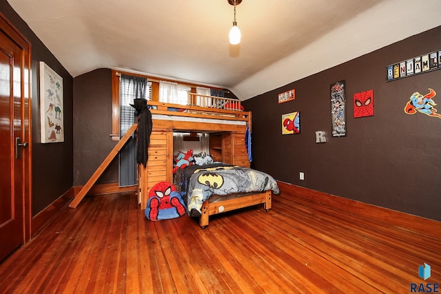 bedroom with lofted ceiling and dark wood-type flooring