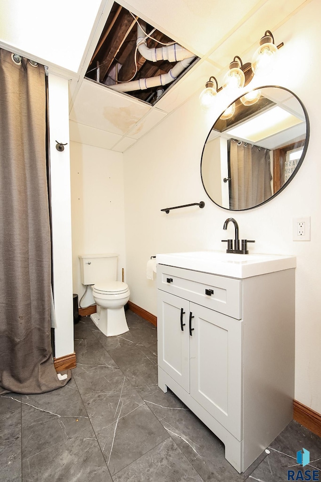 bathroom featuring vanity, toilet, and a shower with shower curtain