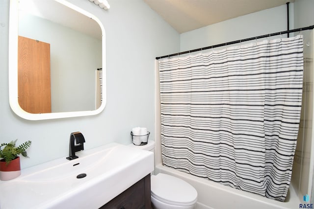 full bathroom with vanity, shower / tub combo, and toilet