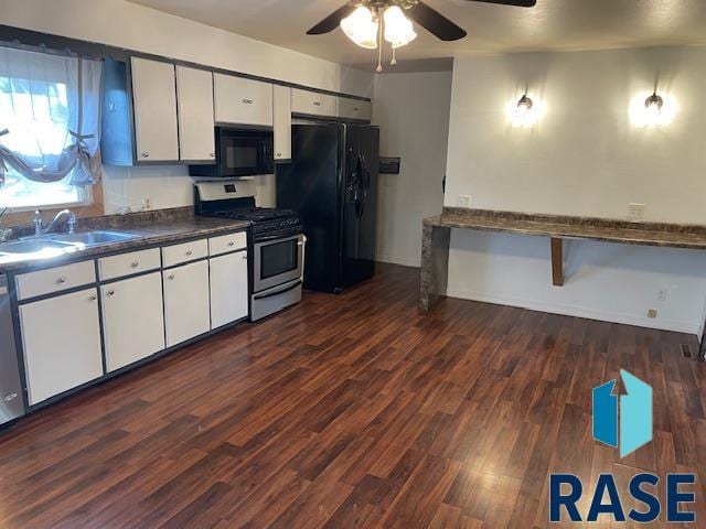 kitchen with dark wood-type flooring, sink, black appliances, ceiling fan, and white cabinets