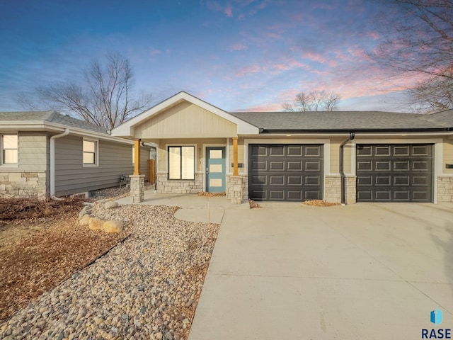 single story home featuring a garage and a porch