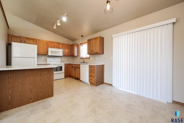 kitchen featuring hanging light fixtures, lofted ceiling, sink, and white appliances