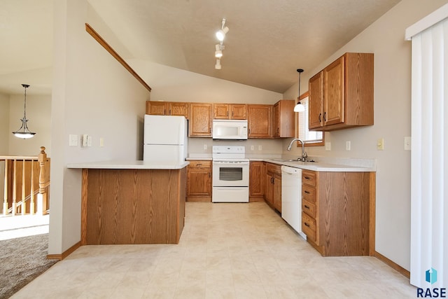 kitchen featuring pendant lighting, sink, white appliances, vaulted ceiling, and kitchen peninsula