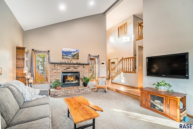 living room featuring a brick fireplace, carpet floors, and high vaulted ceiling