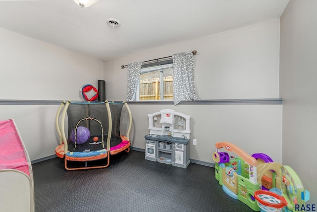 playroom with dark colored carpet