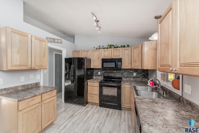 kitchen featuring sink, black appliances, decorative light fixtures, vaulted ceiling, and light brown cabinets