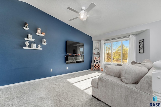 living room with vaulted ceiling, carpet floors, and ceiling fan