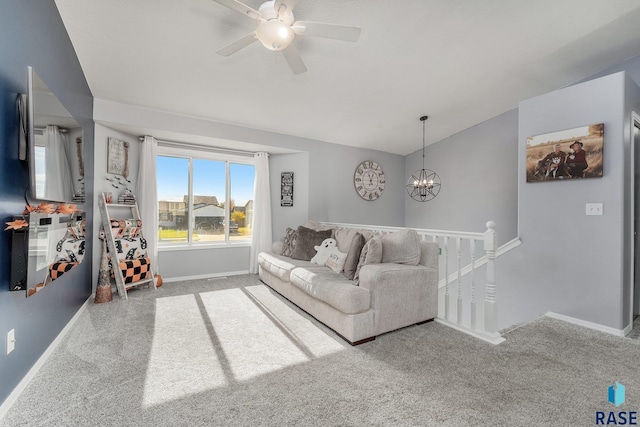 living room with lofted ceiling, ceiling fan with notable chandelier, and carpet