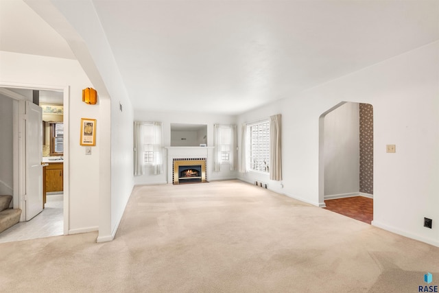 unfurnished living room featuring light colored carpet