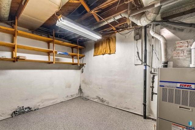 basement with heating unit and carpet floors