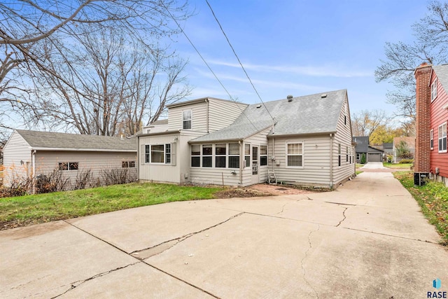 rear view of property featuring a yard