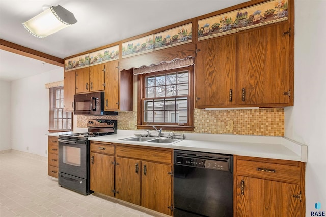 kitchen featuring sink, decorative backsplash, and black appliances