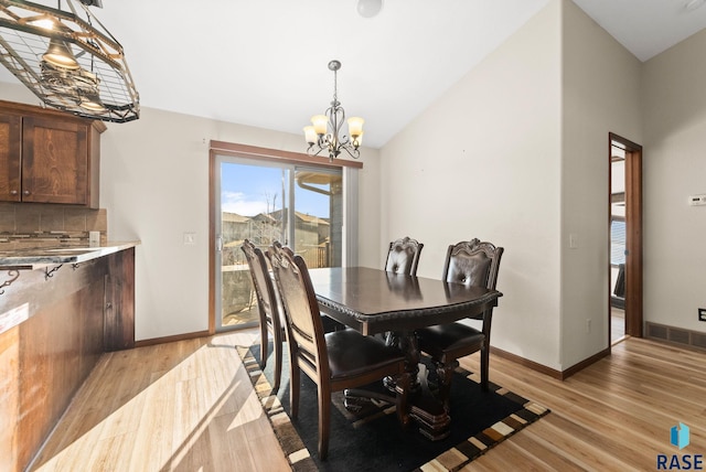 dining area featuring a notable chandelier and light wood-type flooring