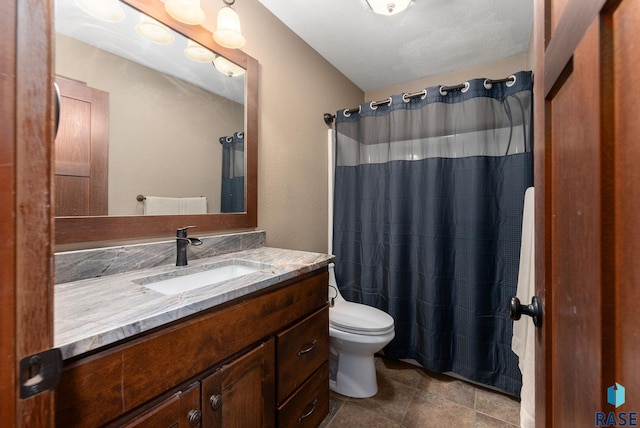 bathroom featuring walk in shower, vanity, and toilet