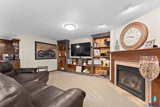 carpeted living room with a tile fireplace