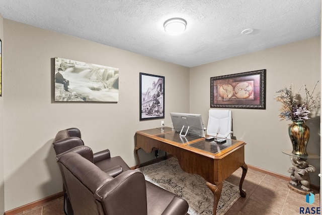 office space with light tile patterned floors and a textured ceiling