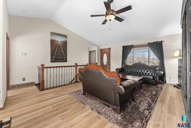 living room featuring lofted ceiling, ceiling fan, and light wood-type flooring