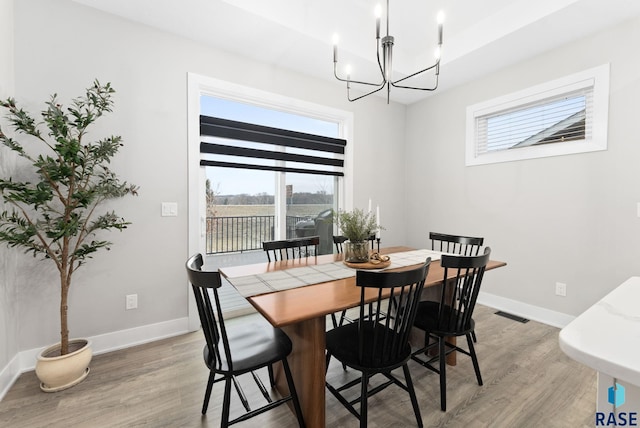 dining area with a chandelier and light hardwood / wood-style floors