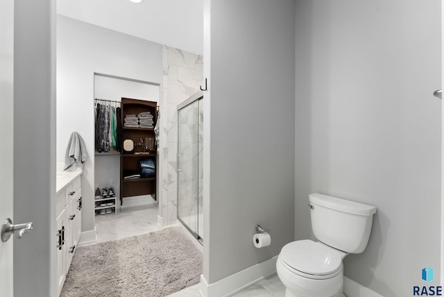 bathroom featuring vanity, toilet, and an enclosed shower