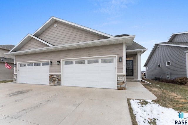 view of front of property with cooling unit and a garage