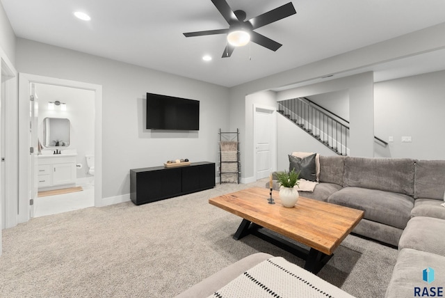 carpeted living room with ceiling fan