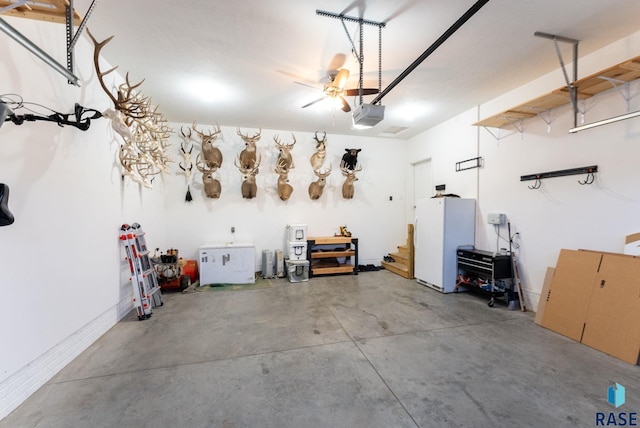 garage with a garage door opener and white refrigerator