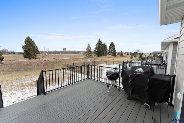 wooden terrace featuring grilling area and a rural view