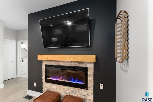 interior details featuring hardwood / wood-style floors and a fireplace