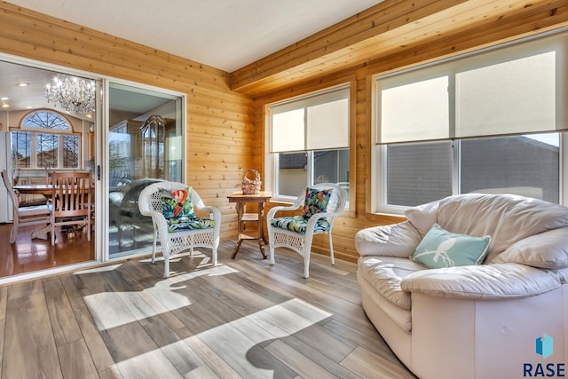 sunroom / solarium with an inviting chandelier