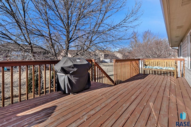 wooden terrace featuring area for grilling