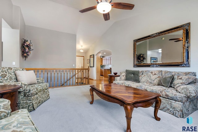 living room featuring vaulted ceiling, carpet floors, and ceiling fan