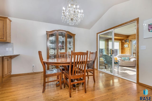 dining area with a chandelier and light hardwood / wood-style flooring