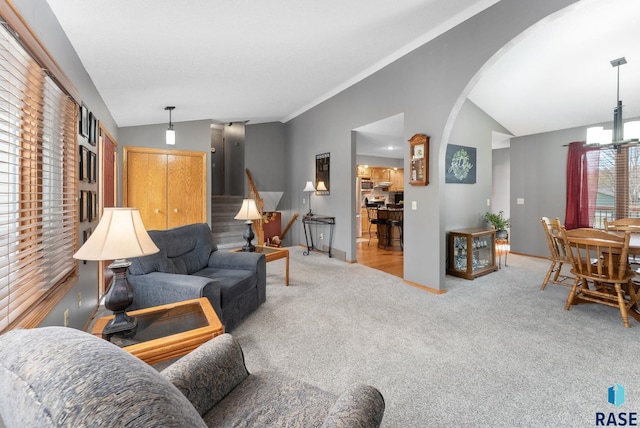 living room featuring lofted ceiling and light colored carpet