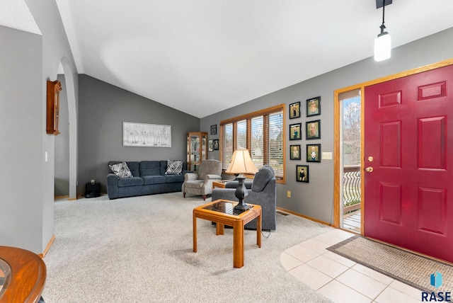 living room with lofted ceiling and light colored carpet