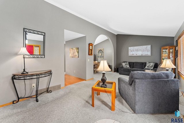 carpeted living room with vaulted ceiling