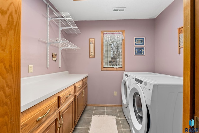 laundry area with cabinets, washer and dryer, and light tile patterned floors