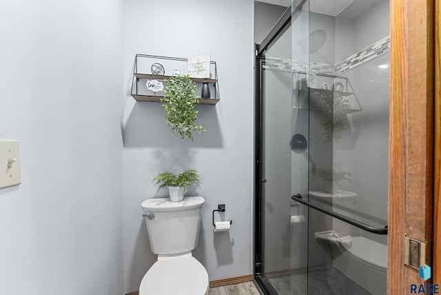 bathroom with toilet and walk in shower