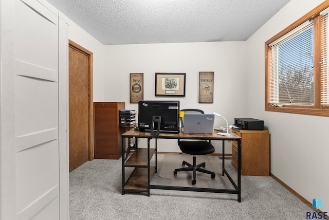 office area with light carpet and a textured ceiling