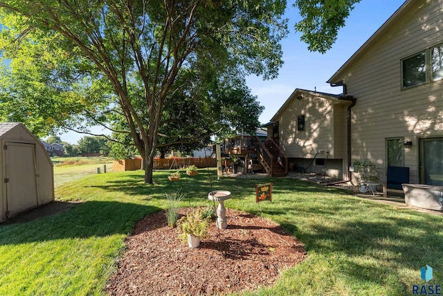 view of yard with a deck and a storage unit