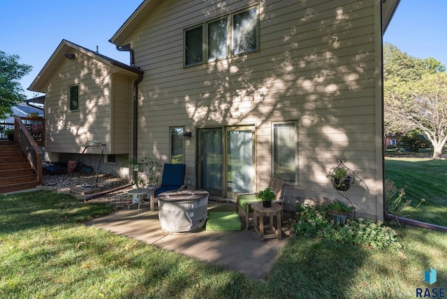 rear view of house with a patio and a yard